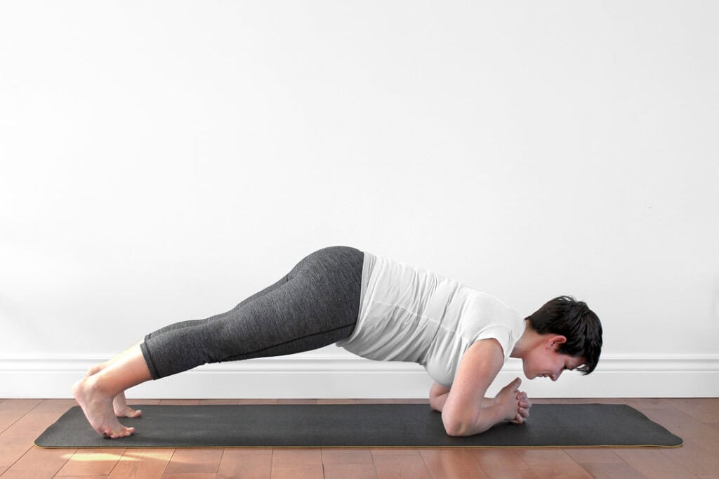 Dolphin push-up shifting forward over the hands, first trimester prenatal yoga
