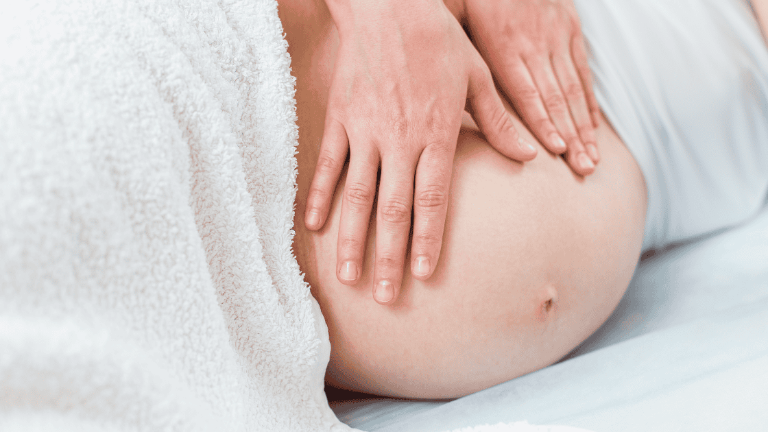 pregnant woman receiving prenatal massage in second trimester at kāer Toronto
