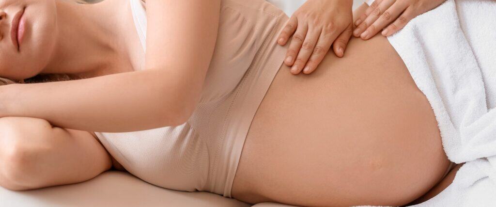 pregnant woman enjoying prenatal massage at Toronto wellness clinic