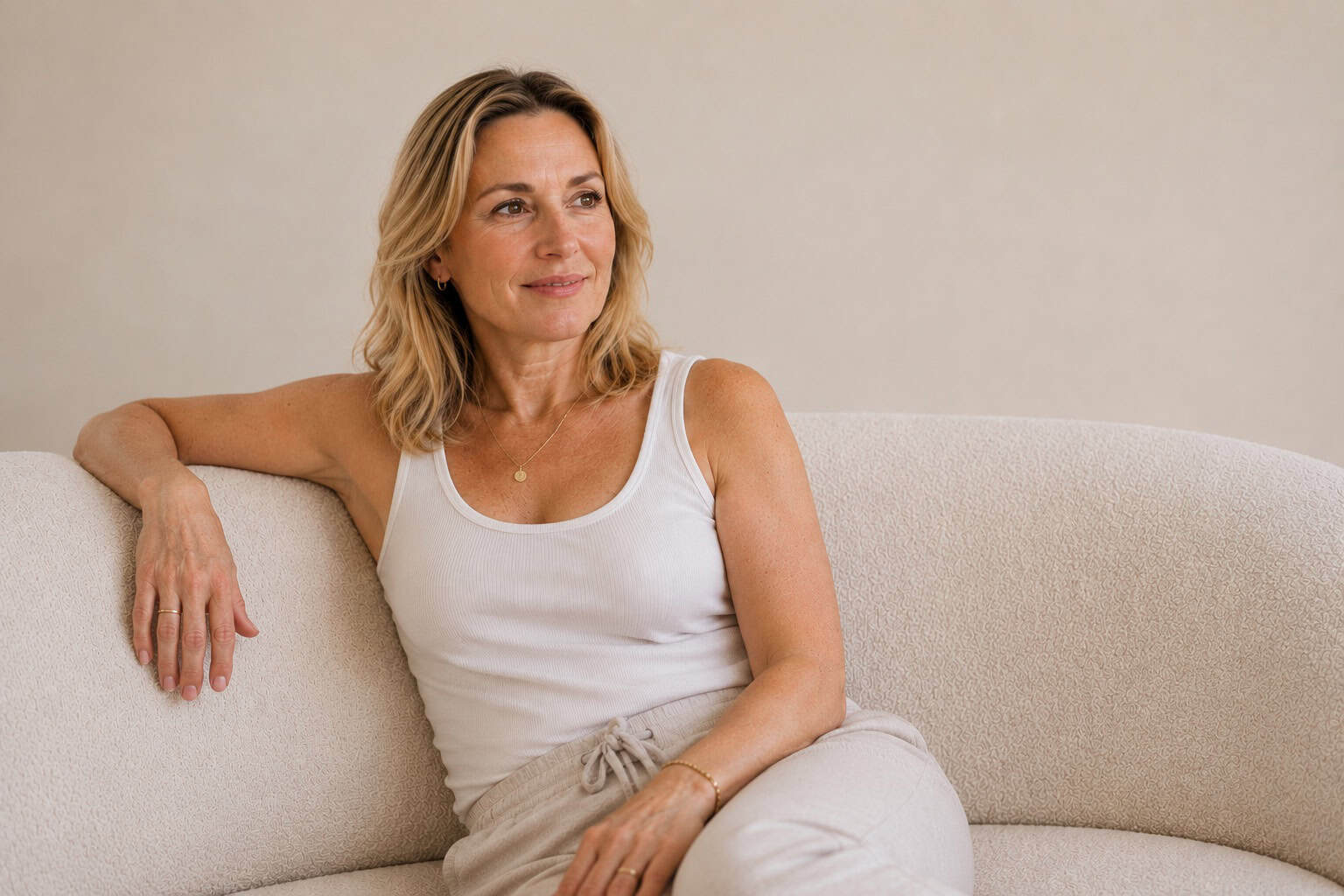 Woman at ease in a bright living space, pelvic floor dysfunction treatment at kaer Toronto